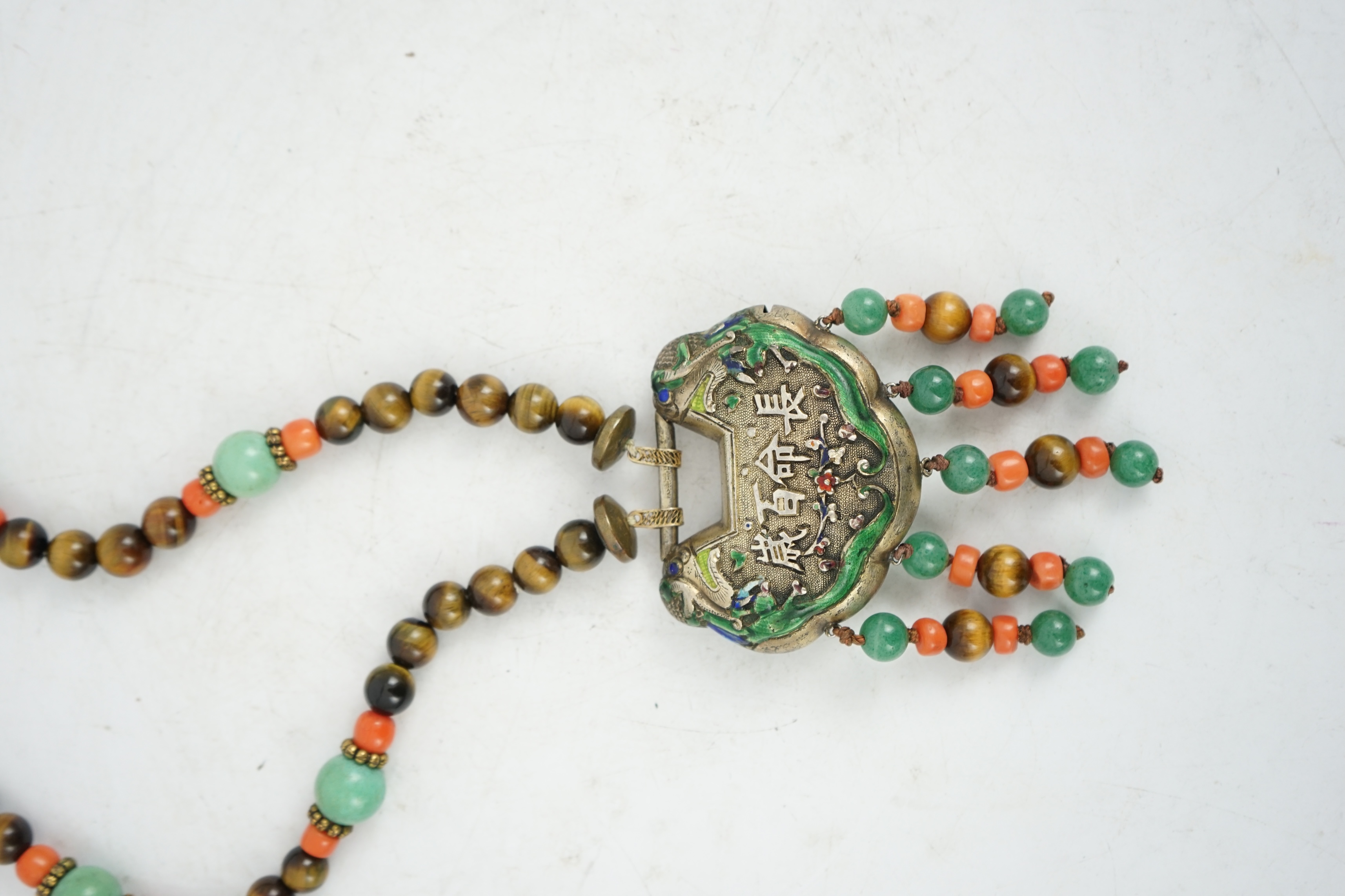 A Chinese silver and enamel amulet tiger's eye, coral and turquoise bead necklace, housed in a liberty box. Condition - good